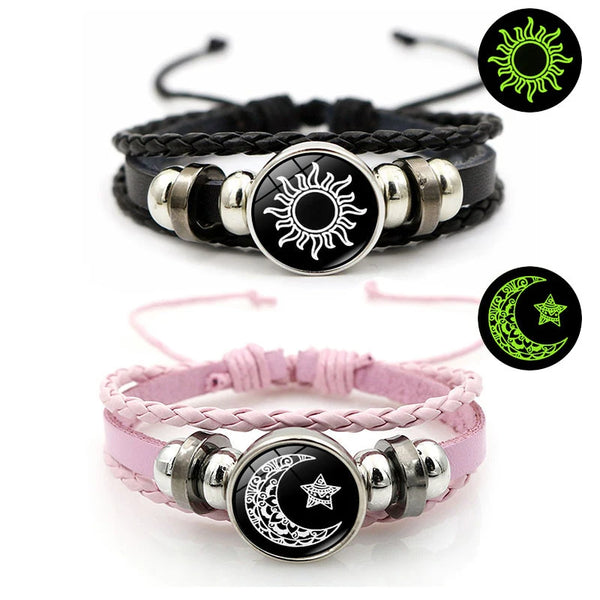 A pair of black and pink couple bracelets featuring sun and moon designs.