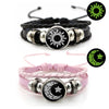 A pair of black and pink couple bracelets featuring sun and moon designs.