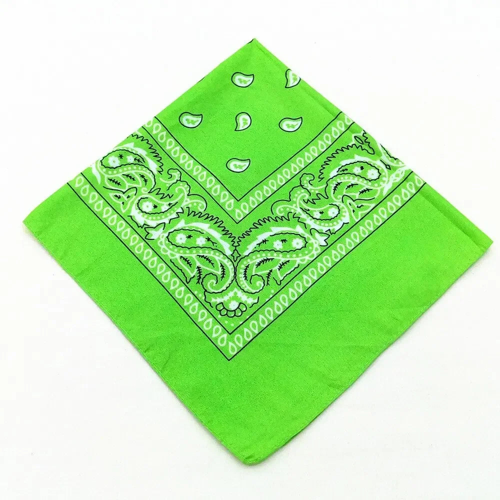 A bright lime green bandana featuring an intricate white bohemian print design.