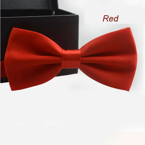 Nœud papillon satin rouge uni présenté sur un fond sombre.