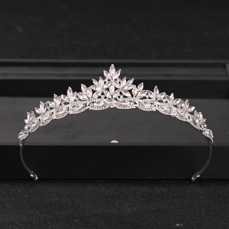 A sparkling crystal rhinestone bridal tiara headpiece displayed on a dark surface.
