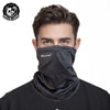 A man wearing a black patterned mask scarf around his neck.