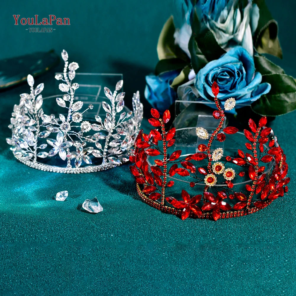 A sparkling rhinestone bridal hair hoop is displayed next to a clear crystal crown on a teal velvet background.