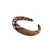 A brown and black plaid sponge headband with a gold accent.