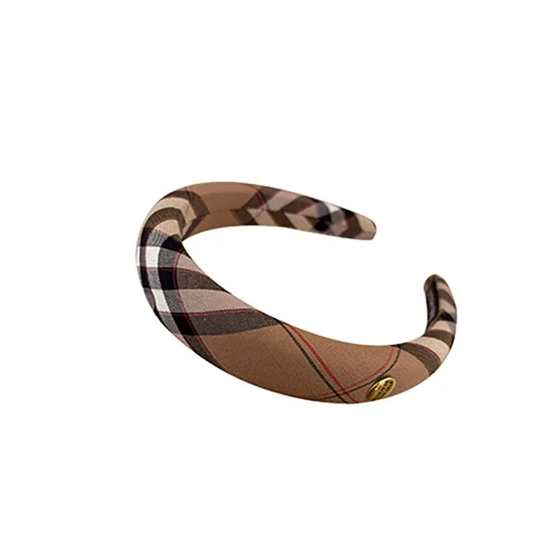 A brown and black plaid sponge headband with a gold accent.