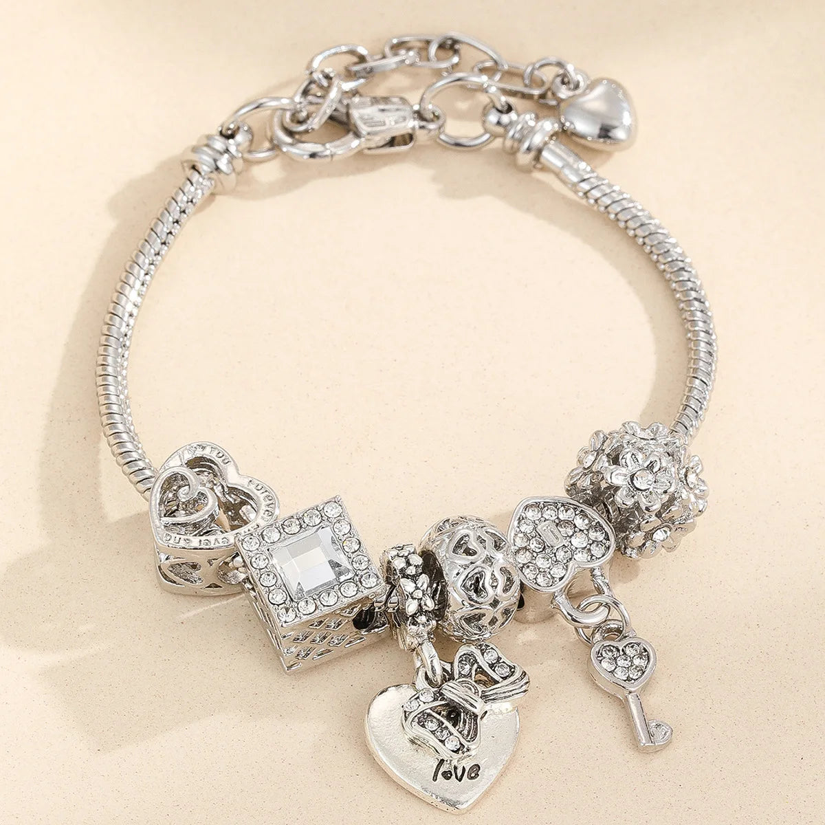 Silver multi-element beaded love bracelet set featuring hearts and charms