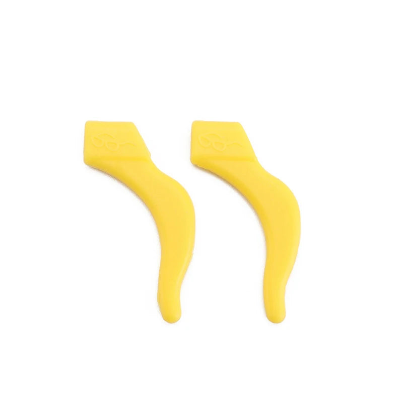 A pair of yellow silicone ear hooks designed for eyeglasses and active use.