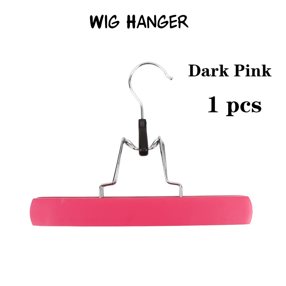 A single dark pink wooden wig hanger with a metal hook and bar.
