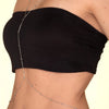 A woman wearing a black crop top with an adjustable belly chain body jewelry detail.