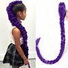 A girl shows off vibrant purple braided hair extensions worn in a long, thick braid.