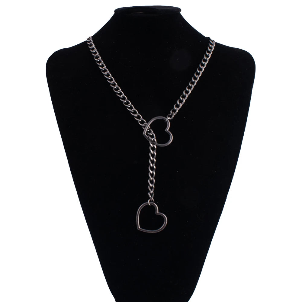 A chunky heart slip chain necklace displayed on a black display stand.