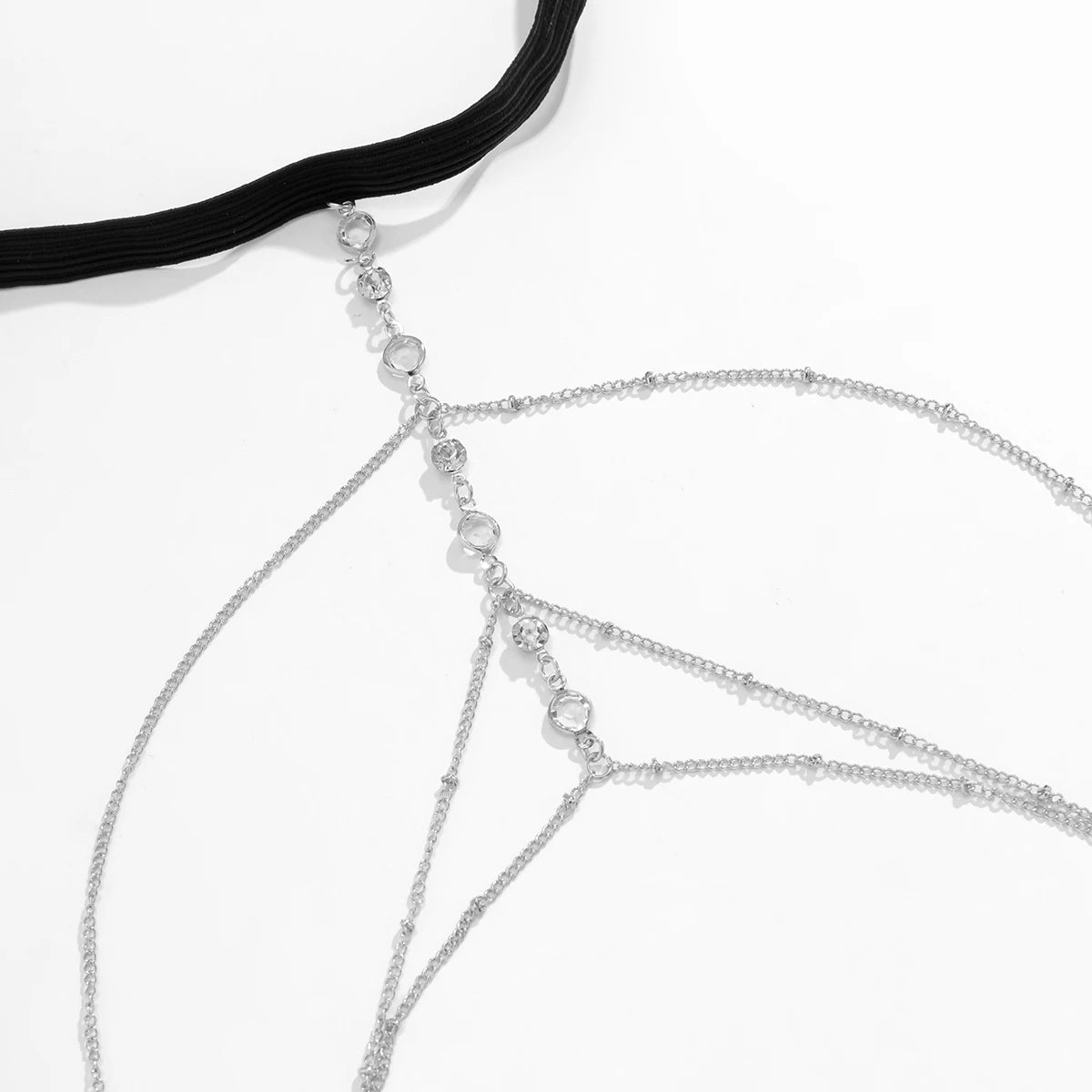 Silver crystal body chain jewelry featuring delicate chains and a black strap.
