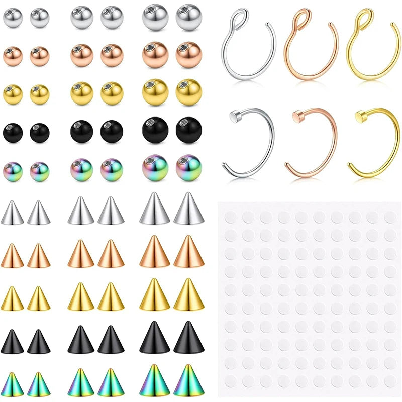 A collection of various replacement fake eyebrow and lip labret studs in silver, gold, and black finishes.