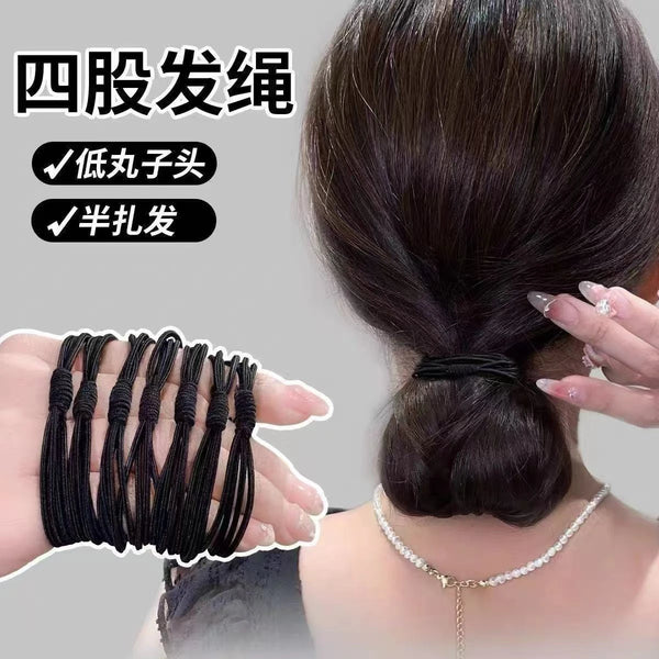 Black elastic hair ties used to secure a ponytail on a woman's head