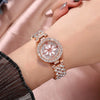 A close-up of a rose gold rhinestone quartz watch and bracelet set worn on a wrist.