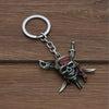 Silver skull pendant necklace with a ring, featuring a red and black design.