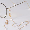 Gold-toned pearl sunglasses with a chain lanyard and gold ear hooks