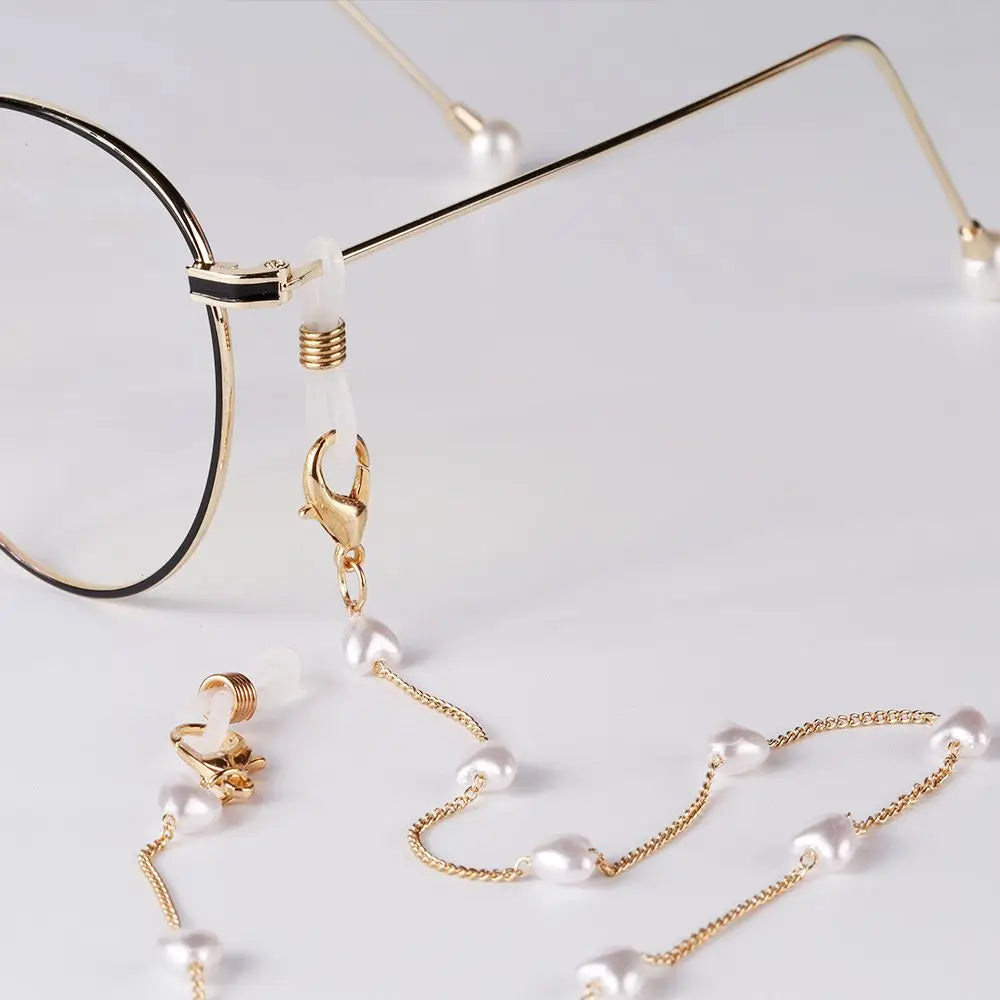 Gold-toned pearl sunglasses with a chain lanyard and gold ear hooks