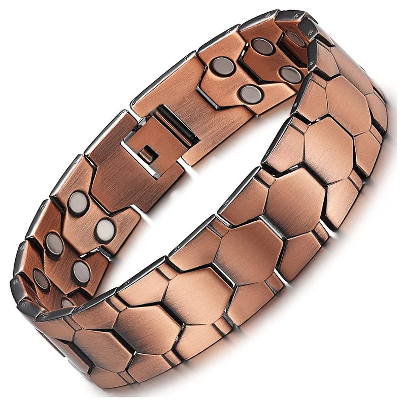 A close-up view of a copper magnetic therapy bracelet with hexagonal links and a rectangular clasp.