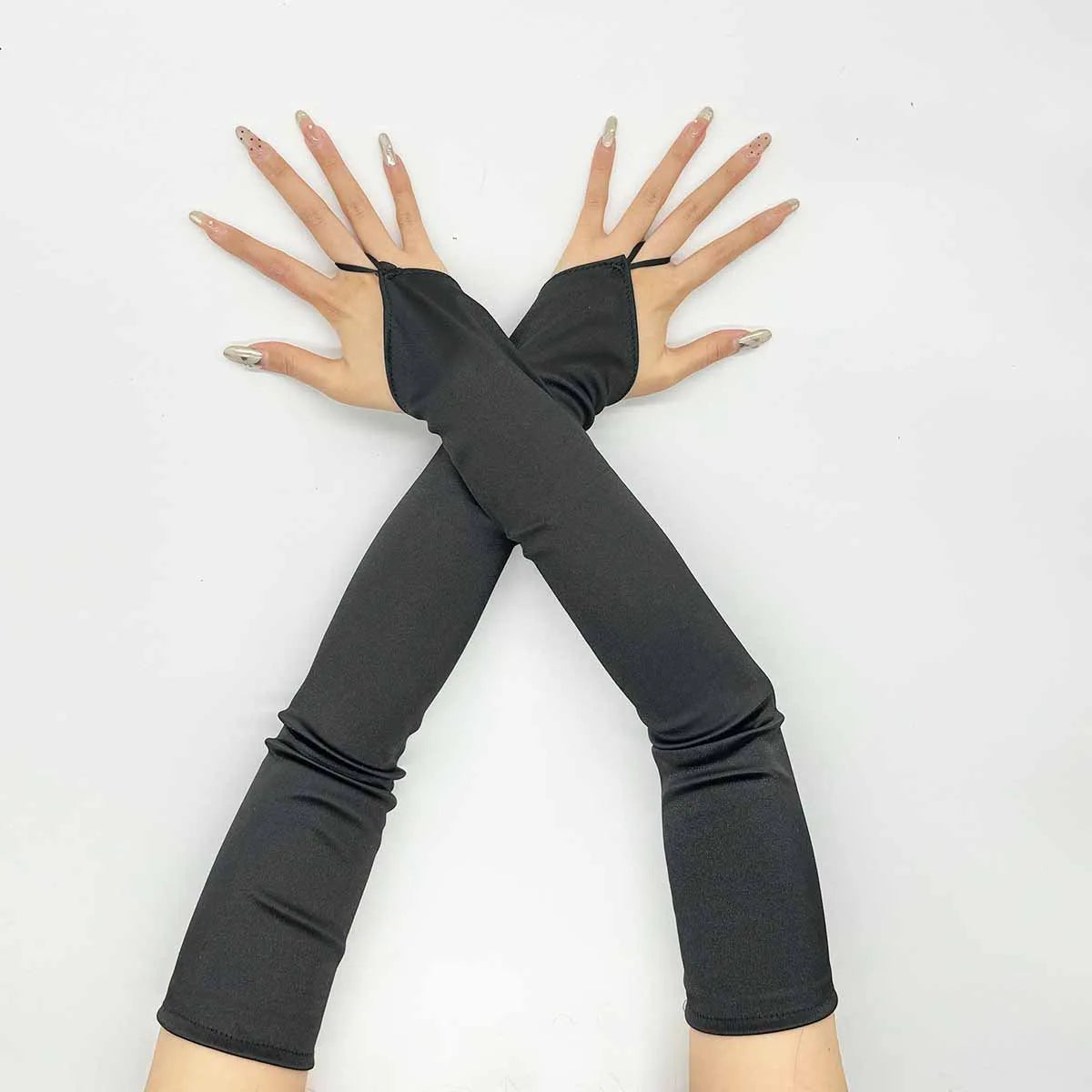 A pair of black satin fingerless gloves with metallic accents are displayed in an X shape against a white background.