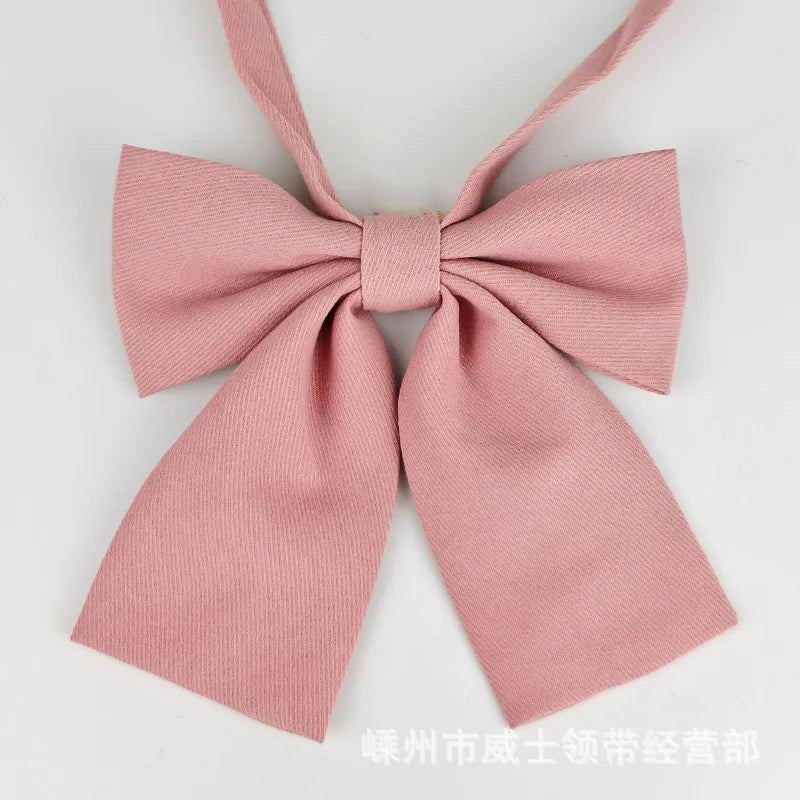 A pink butterfly ribbon tie set for students featuring a bow design.