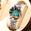 A close-up of an elegant stainless steel quartz ladies wristwatch with a teal dial and rose gold accents, displayed on a ligh