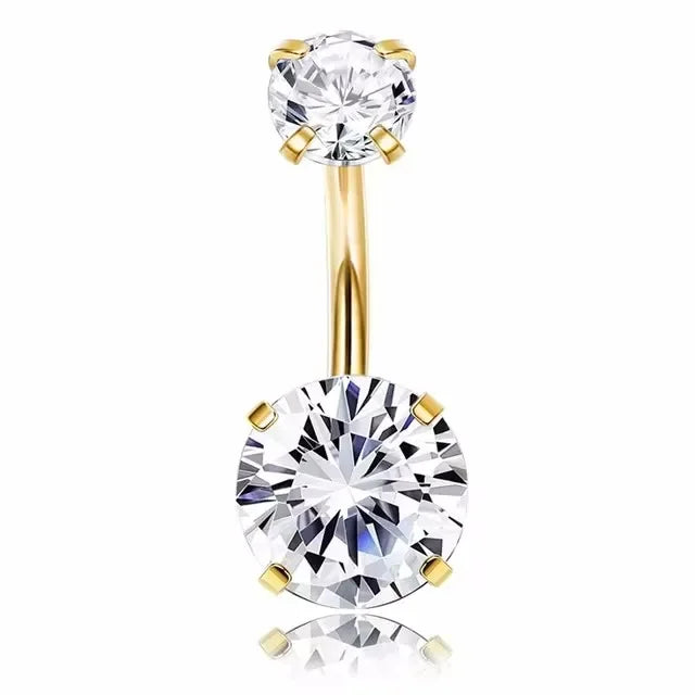 A surgical stainless steel belly button ring featuring a clear round gemstone and a gold-toned setting.