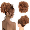 A woman shows off a reddish-brown synthetic curly chignon hairstyle, featuring voluminous curls and a messy bun texture.