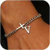 A close-up of a personalized stainless steel cross Cuban chain bracelet worn on a wrist.