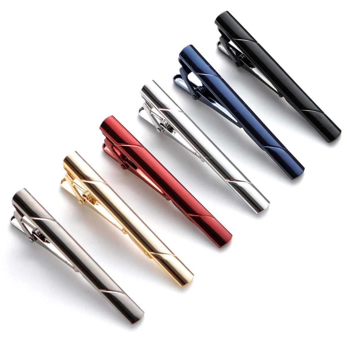 A collection of various 14K copper classic tie clip jewelry in black, blue, red, and gold finishes.