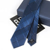 A dark blue striped skinny necktie is displayed next to its presentation box.