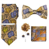 A set of men's formal tie and accessory featuring a patterned silk tie, bow tie, and pocket square.