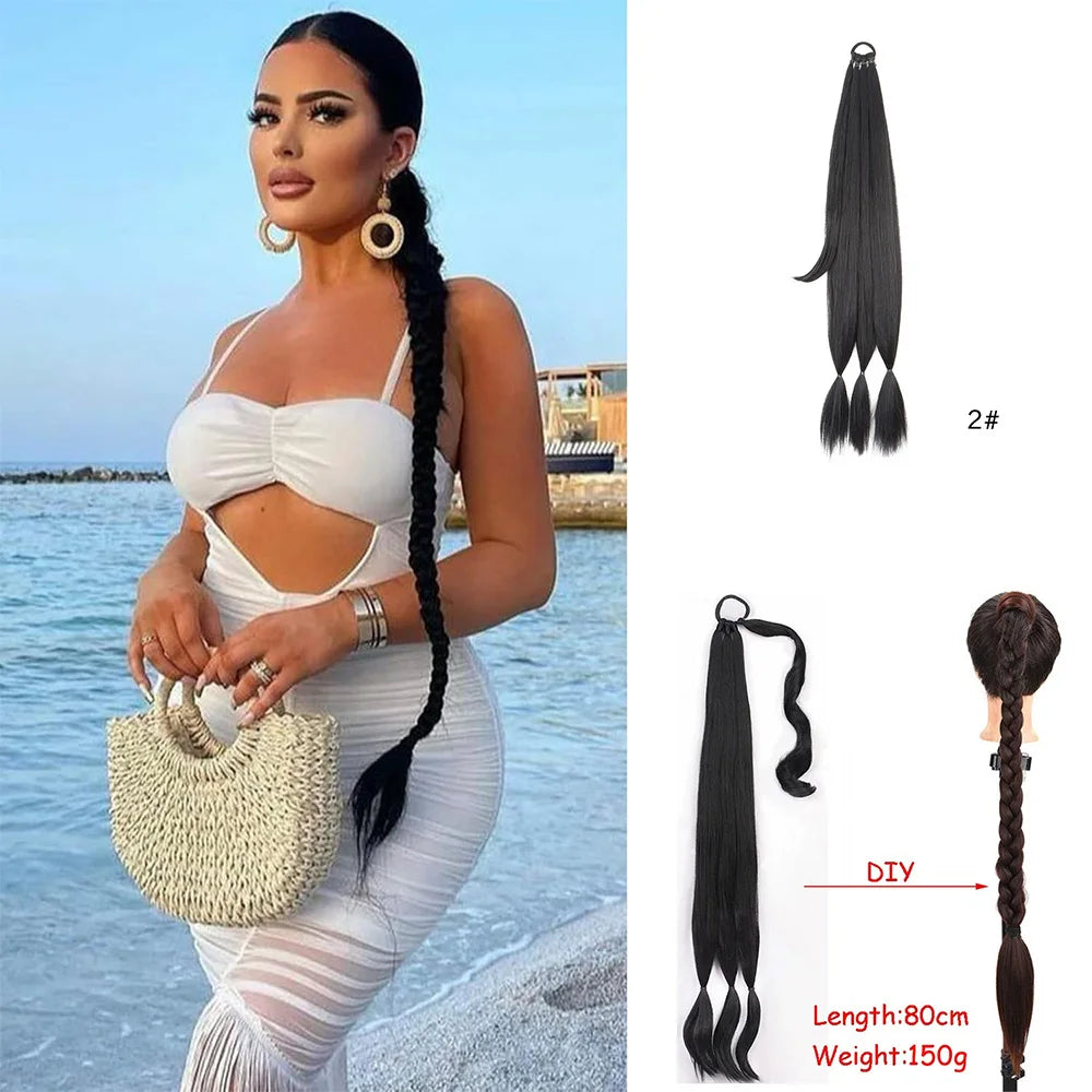 Black synthetic long braided ponytail hair extension with a gold clip and attached to a white dress.