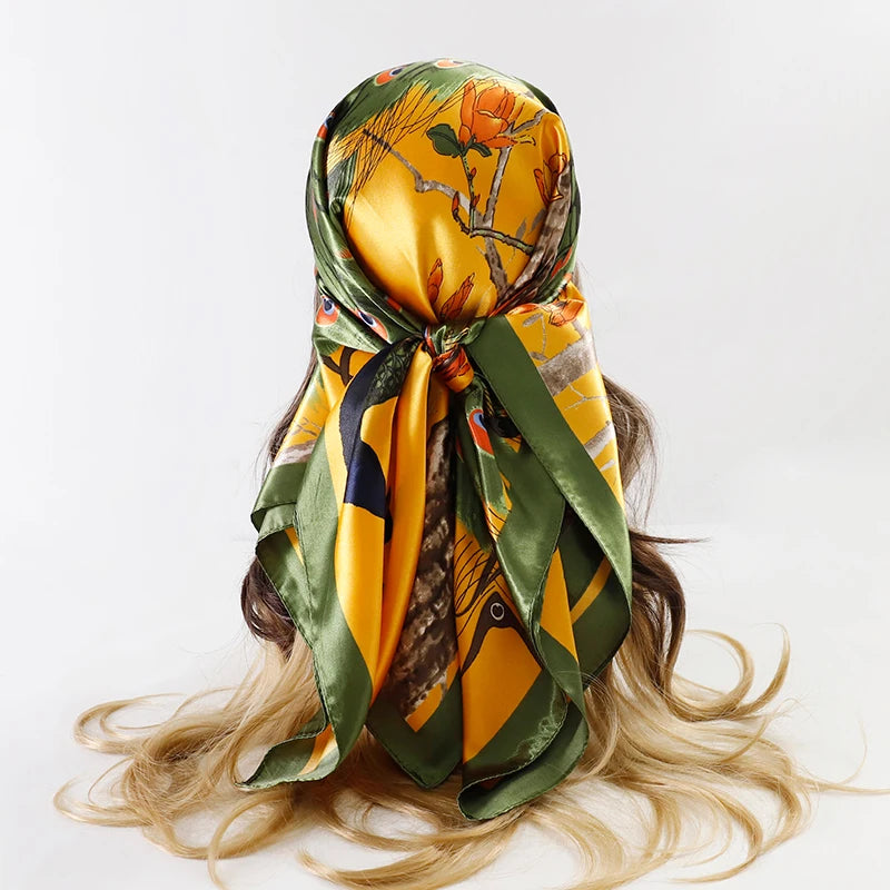 A yellow and green satin silk scarf tied around a woman's hair.