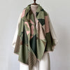 A draped scarf and shawl wrap featuring a patchwork plaid pattern in shades of olive green, pink, and brown.