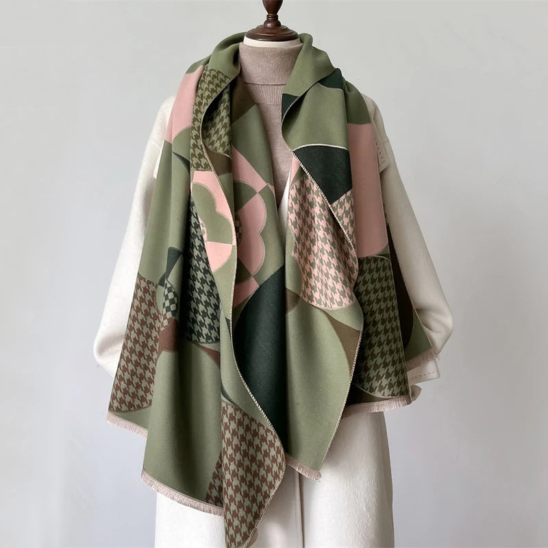 A draped scarf and shawl wrap featuring a patchwork plaid pattern in shades of olive green, pink, and brown.