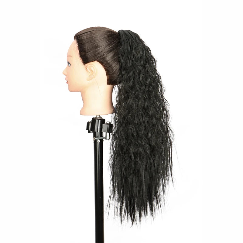 A dark black ponytail hair extension is displayed on a mannequin head.