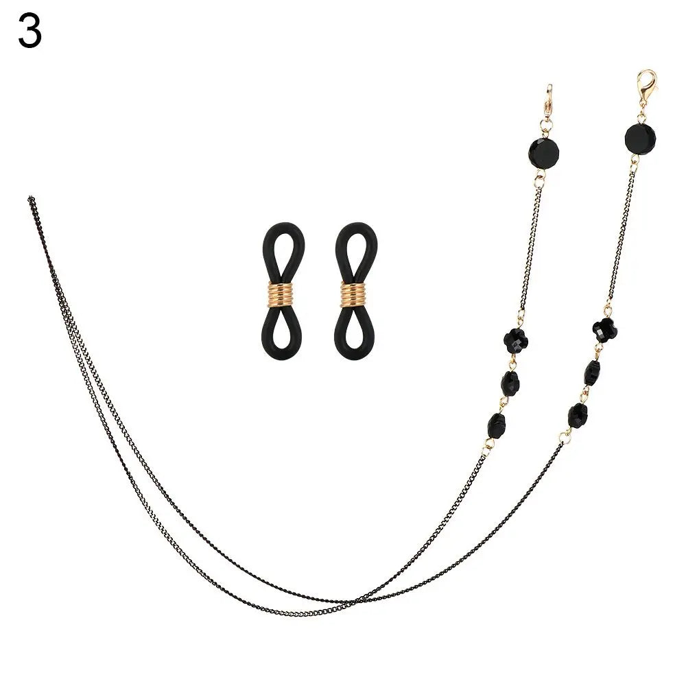 A delicate black chain lanyard with a gold-toned clasp and small black pearl beads.