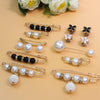 A collection of adjustable pearl and black bead jewelry including earrings and bracelets displayed on a light background.