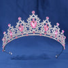 An elegant crystal rhinestone tiara and headband set featuring pink gemstones.