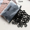 A pile of black elastic hair bands is shown next to a gray silicone pouch and a measuring tape.