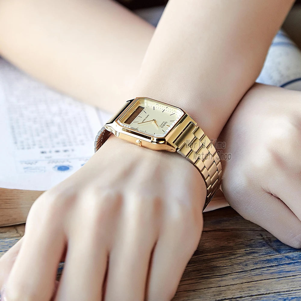 A close-up of a classic gold military style wristwatch worn on a person's wrist.