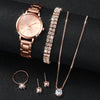 A set of rose gold quartz wrist watch, a matching bracelet, and a delicate necklace with diamond pendants.