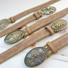A set of vintage PU leather boho western belts with ornate metal buckles and decorative embossing.