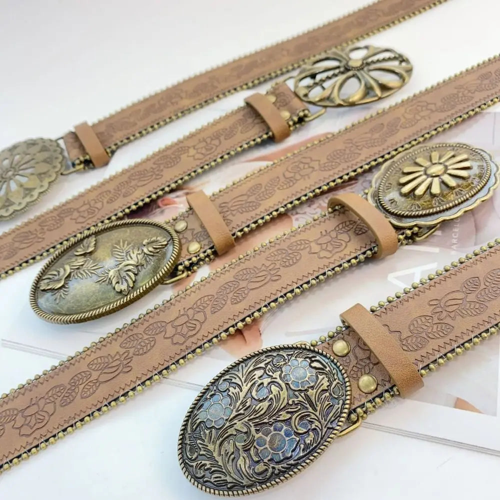 A set of vintage PU leather boho western belts with ornate metal buckles and decorative embossing.