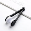 A black portable tool with a white cleaning pad is shown resting on a sheet of paper.