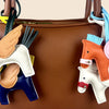 A close-up of an elegant winged pony keychain featuring leather and fabric accents.