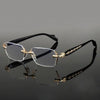 A pair of retro full-frame anti-blue light eyewear with gold accents resting on a reflective surface.