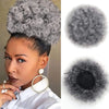 Close-up of a woman wearing Kinky Drawstring Ponytail Extension with a gray curly wig and gold hoop earrings.