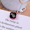 A pink LED digital keychain watch is placed on a white paper with handwritten text.